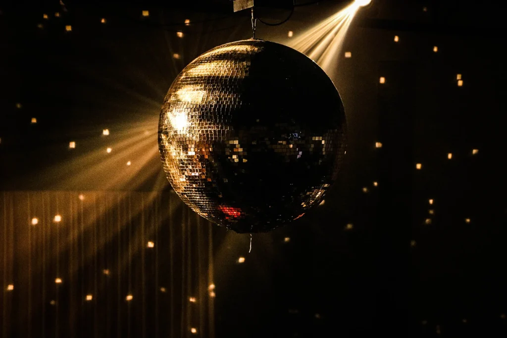 A big disco ball hung from the ceiling with gold speckled lights around it
